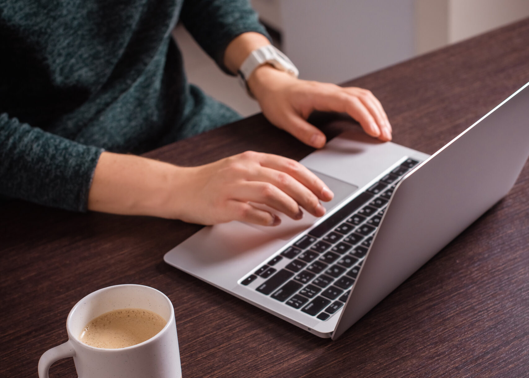 closeup woman hands typing on laptop keyboard, working at home